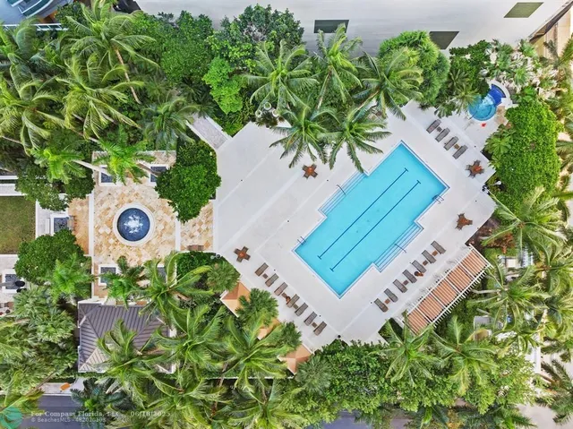 a swimming pool with barbeque oven and trees
