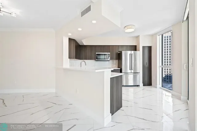 a kitchen with stainless steel appliances a refrigerator and a stove
