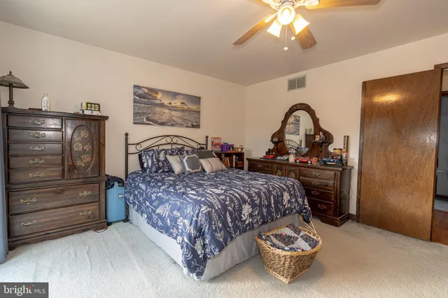 a spacious bathroom with a shower a sink and a mirror