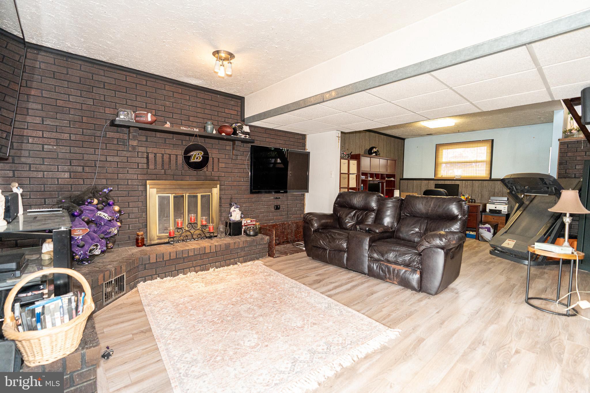 1913 Trout Farm Road Jarrettsville, MD 21084 - Photo 30 of 40 a living room with furniture a flat screen tv and a fireplace