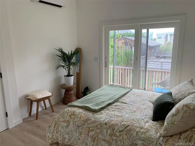 a bedroom with a bed and a potted plant