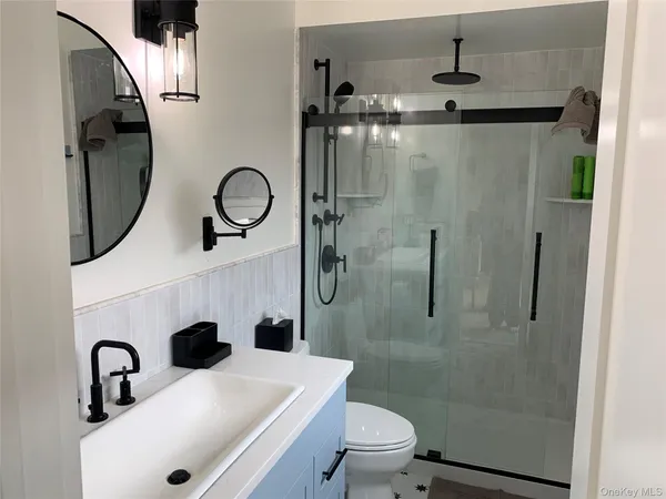 a bathroom with a sink toilet and shower