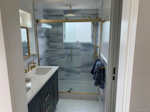 a bathroom with a sink and shower