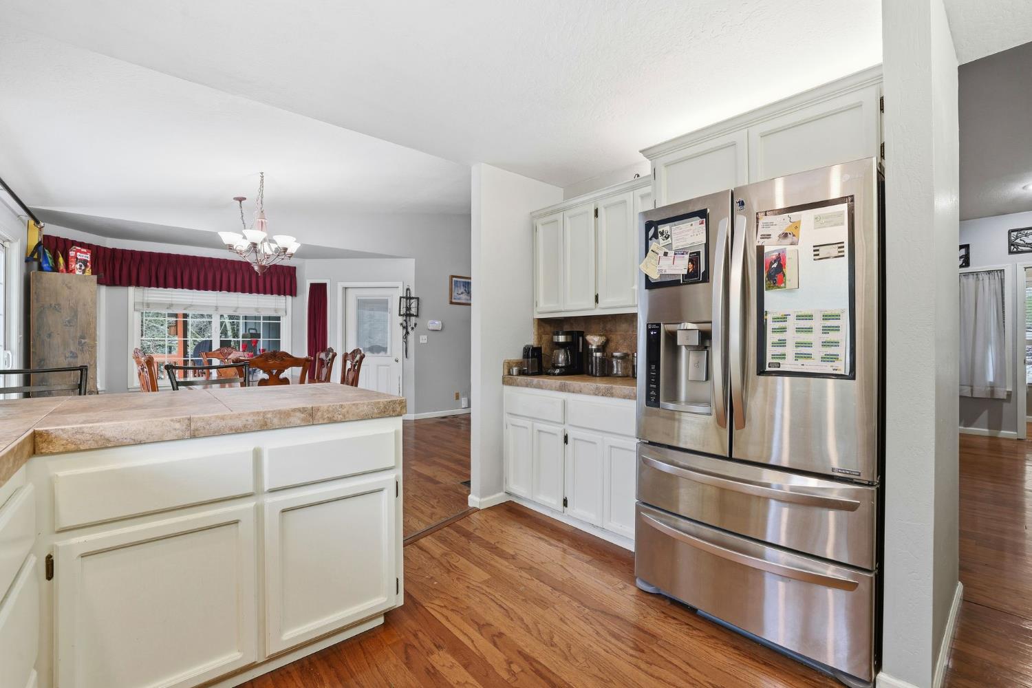 11002 Ball Road Grass Valley, CA 95949 - Photo 11 of 34 a kitchen with stainless steel appliances white cabinets and wooden floor