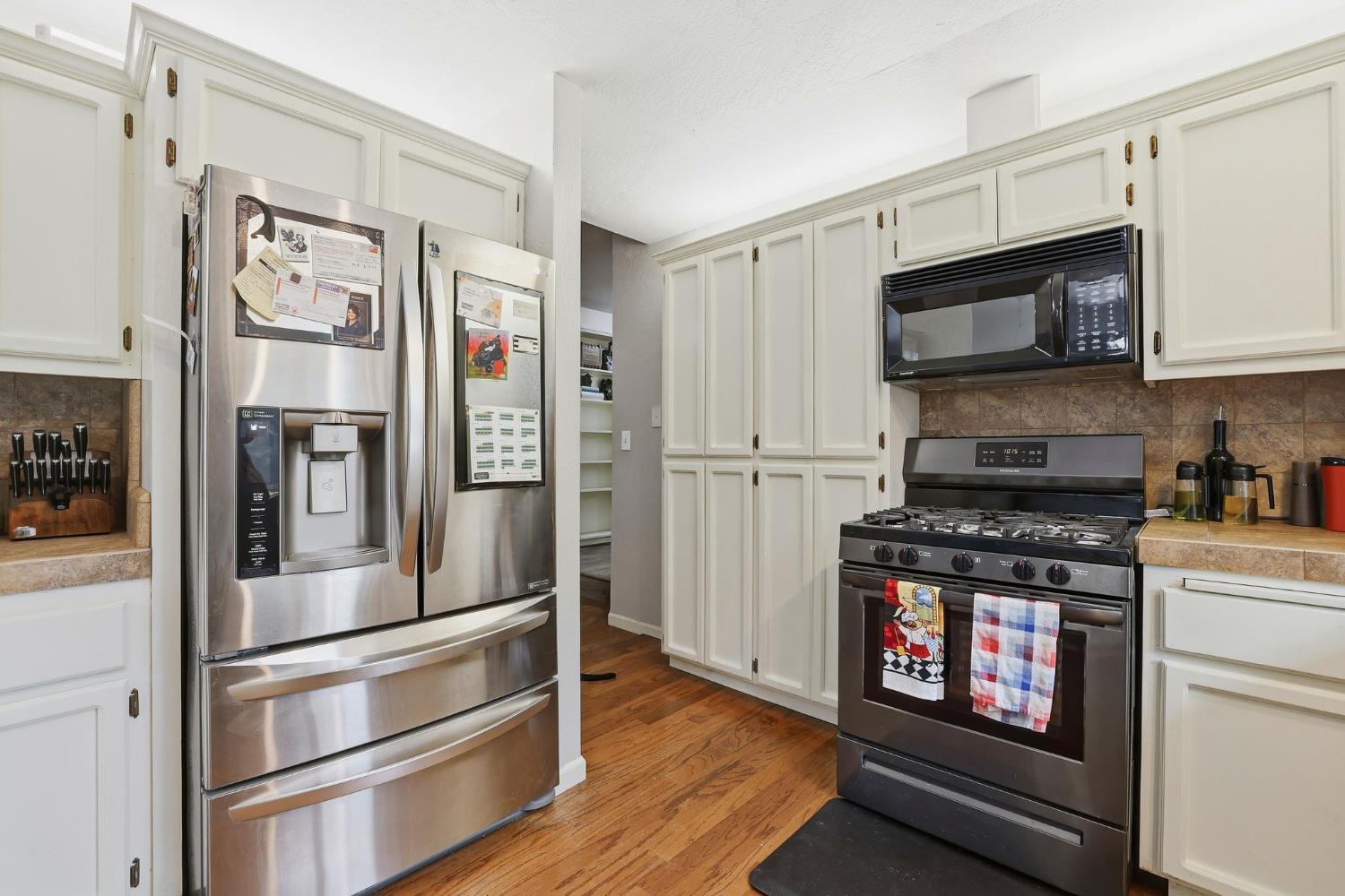 11002 Ball Road Grass Valley, CA 95949 - Photo 12 of 34 a kitchen with stainless steel appliances and wooden floor