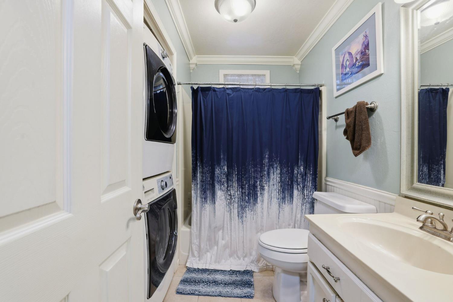 11002 Ball Road Grass Valley, CA 95949 - Photo 17 of 34 a white toilet sitting next to a bathroom sink and a mirror