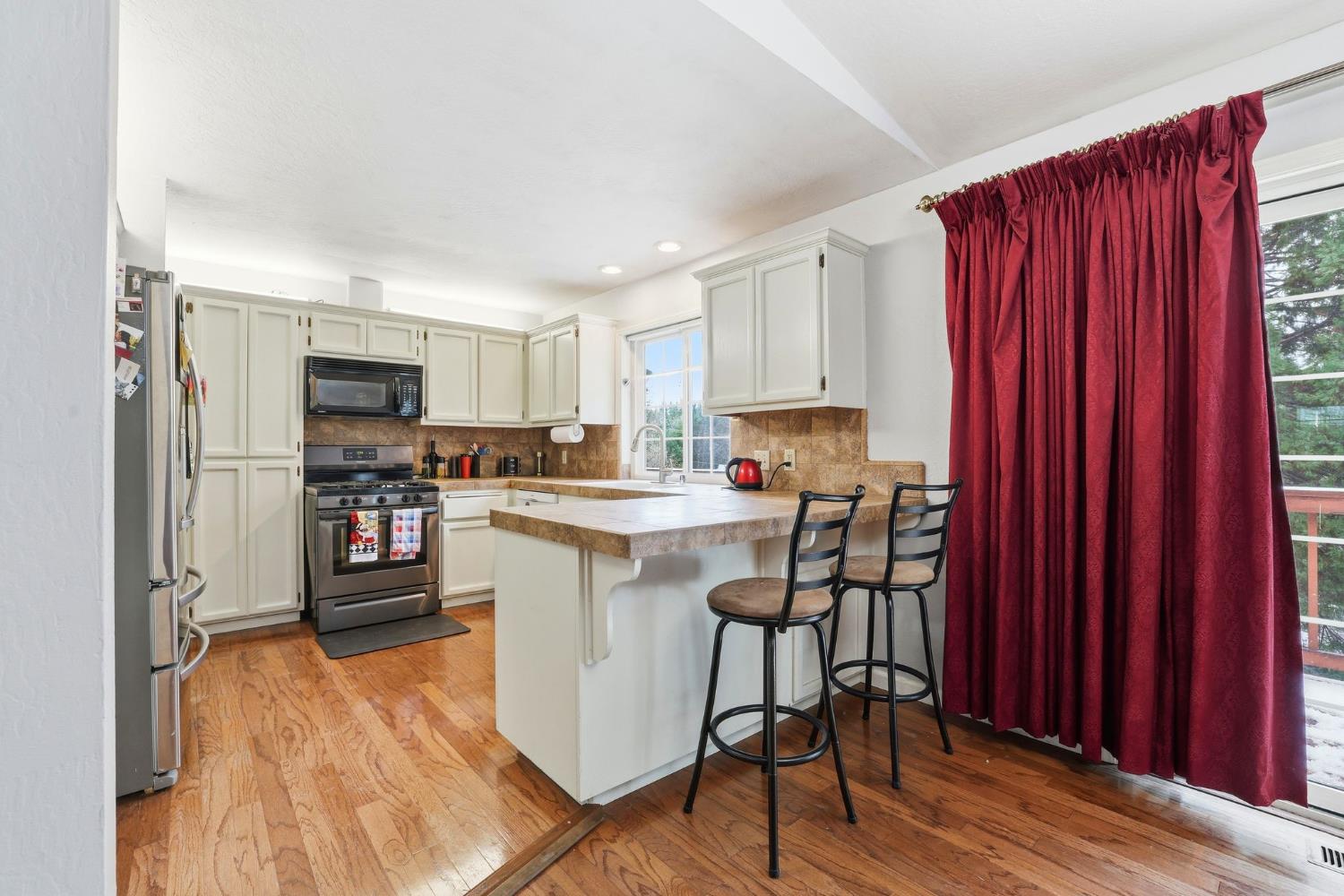 11002 Ball Road Grass Valley, CA 95949 - Photo 8 of 34 a kitchen with granite countertop wooden floors and appliances