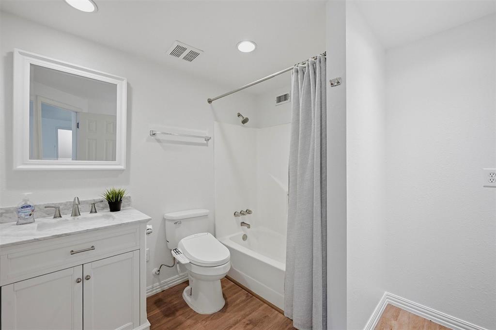 2700 Randell Lake Road Denison, TX 75020 - Photo 27 of 39 a bathroom with a toilet sink a mirror and shower