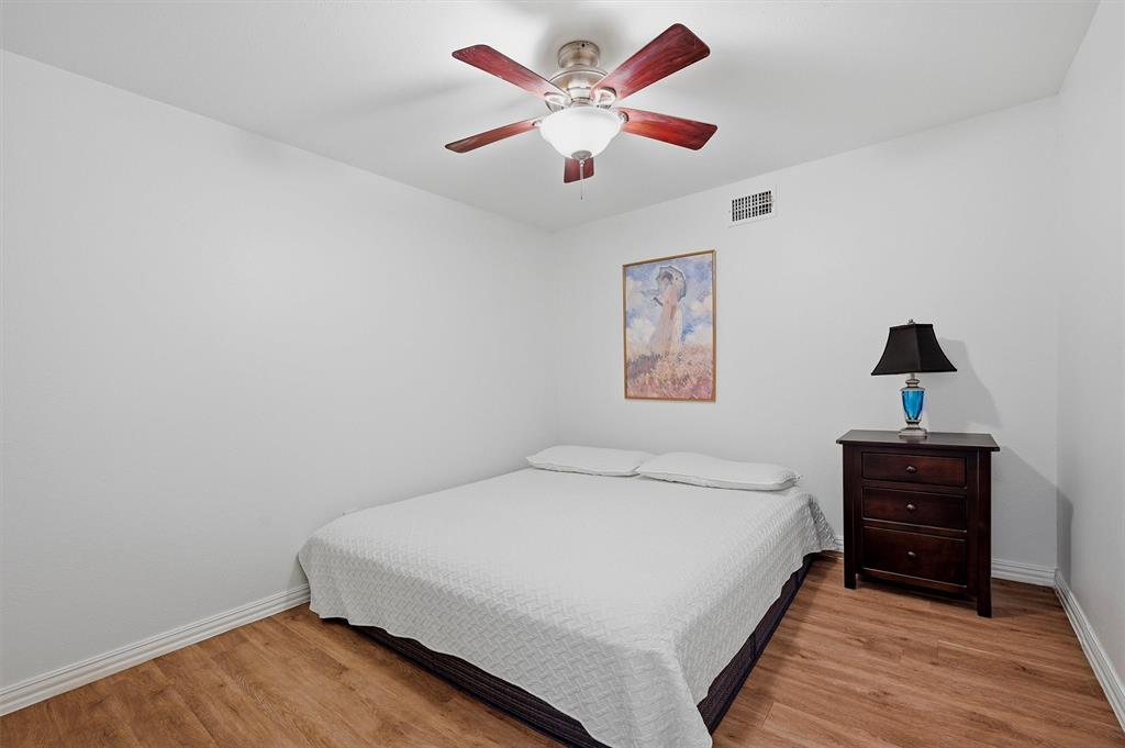 2700 Randell Lake Road Denison, TX 75020 - Photo 28 of 39 a bedroom with a bed and a ceiling fan