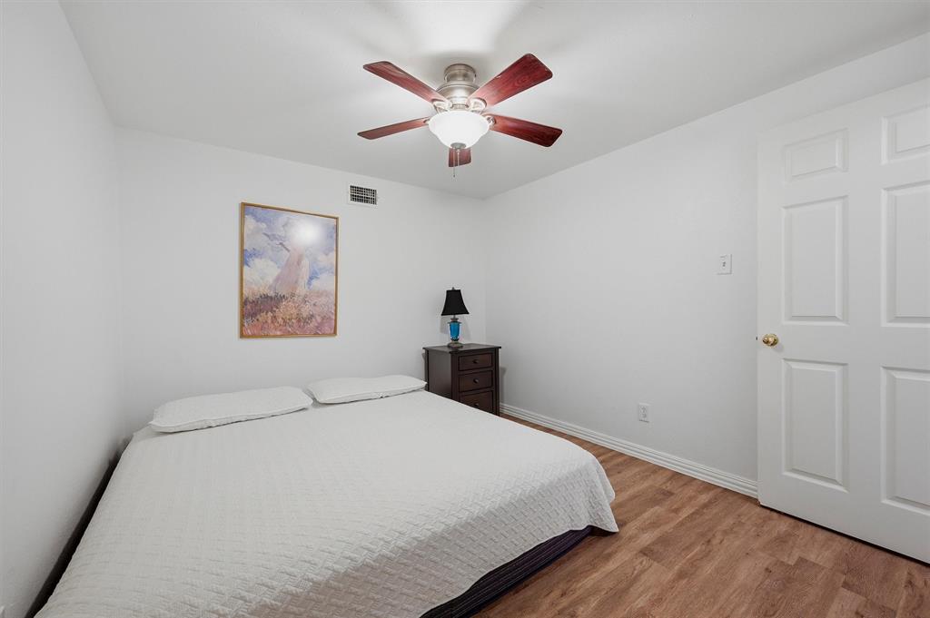 2700 Randell Lake Road Denison, TX 75020 - Photo 29 of 39 a bedroom with a large bed and a chandelier