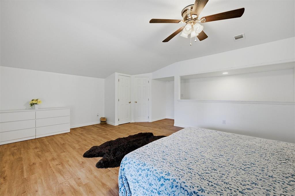 2700 Randell Lake Road Denison, TX 75020 - Photo 30 of 39 a bedroom with a bed and a ceiling fan