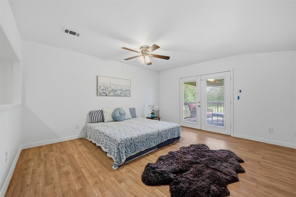 2700 Randell Lake Road Denison, TX 75020 - Photo 31 of 39 a bedroom with a bed and a large window with outer view