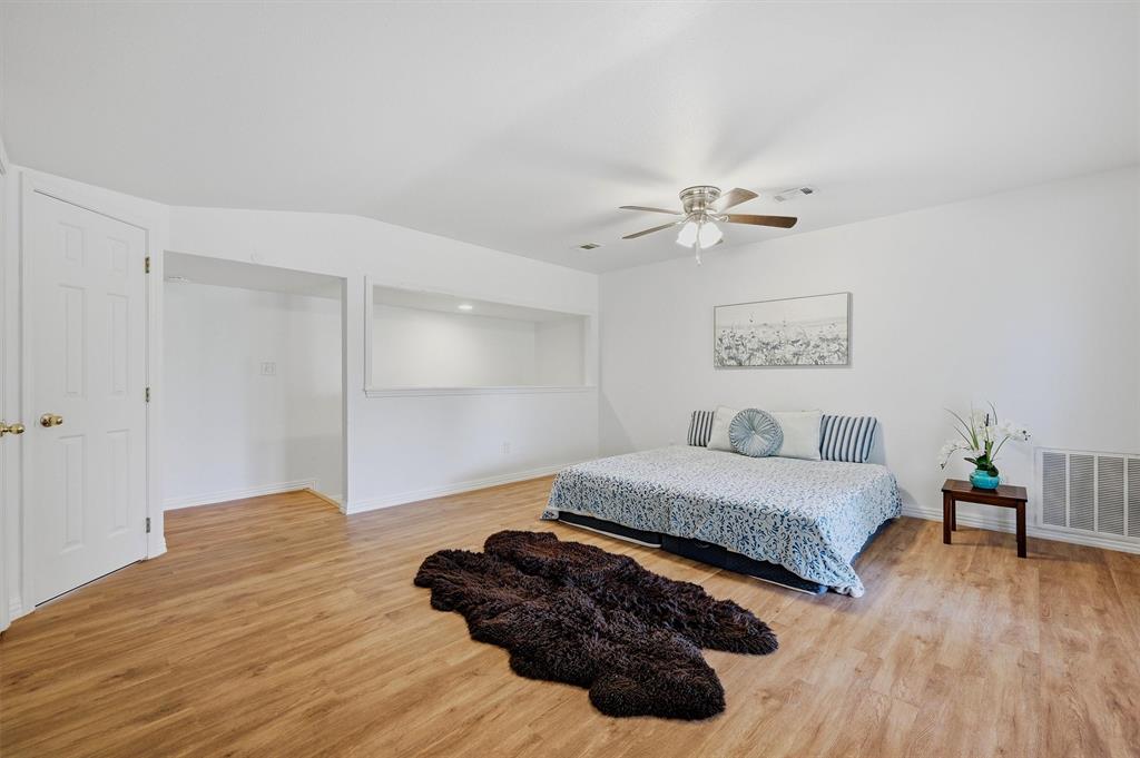 2700 Randell Lake Road Denison, TX 75020 - Photo 32 of 39 a spacious bedroom with a bed and a ceiling fan
