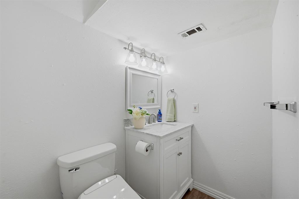 2700 Randell Lake Road Denison, TX 75020 - Photo 33 of 39 a bathroom with a sink a toilet and mirror