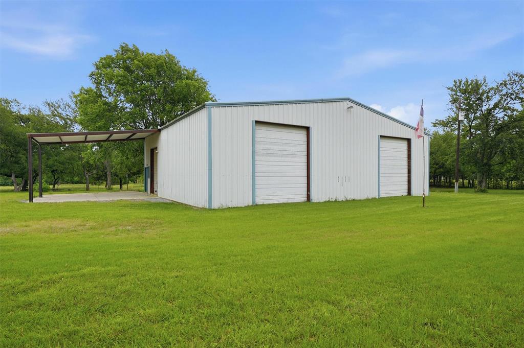 2700 Randell Lake Road Denison, TX 75020 - Photo 5 of 39 a backyard of a house with potted plants and large tree