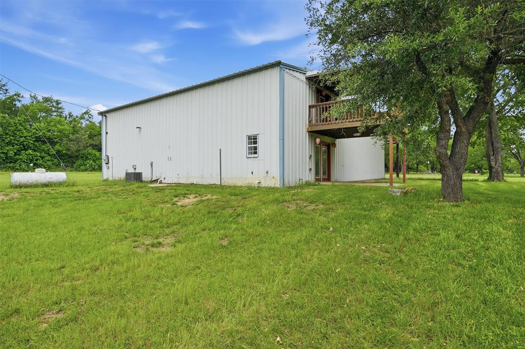 2700 Randell Lake Road Denison, TX 75020 - Photo 7 of 39 Side with elevated deck and lower patio looking to back yard.