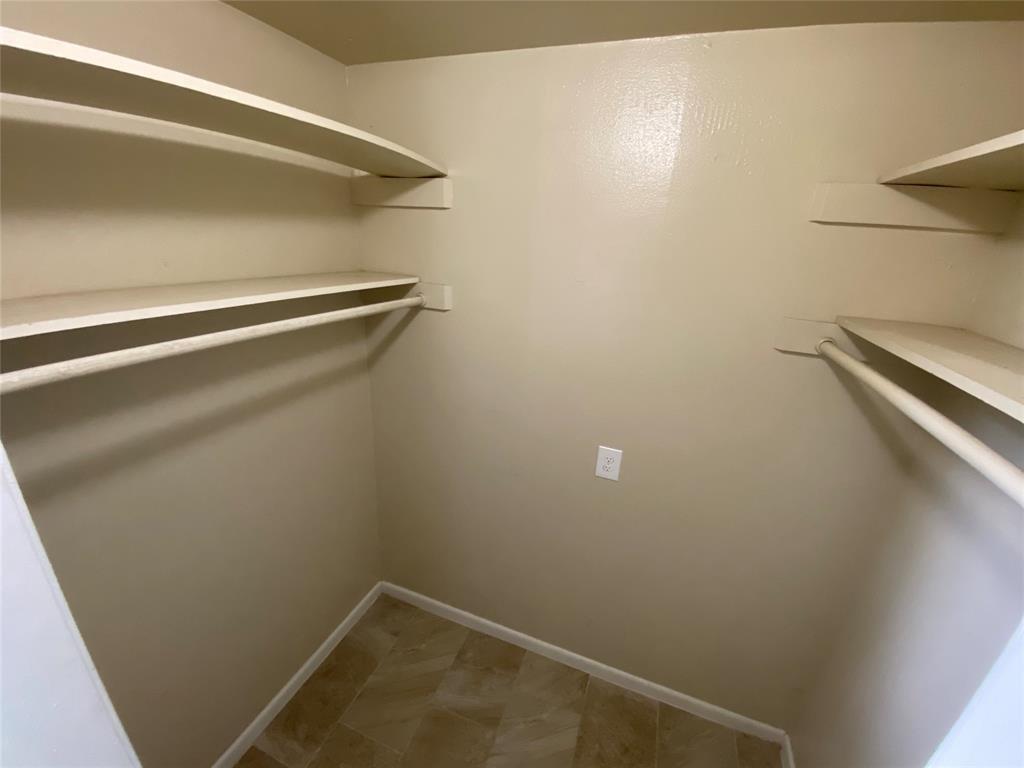 2402 Rio Grande Street, Unit 4 Austin, TX 78705 - Photo 2 of 5 Walk-in closet featuring multiple shelving units and hanging rods