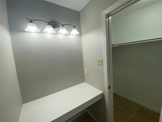 a bathroom with a sink mirror and toilet