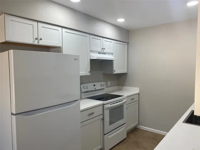 a kitchen with a stove and a refrigerator