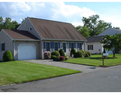 a view of a house with a yard and pathway
