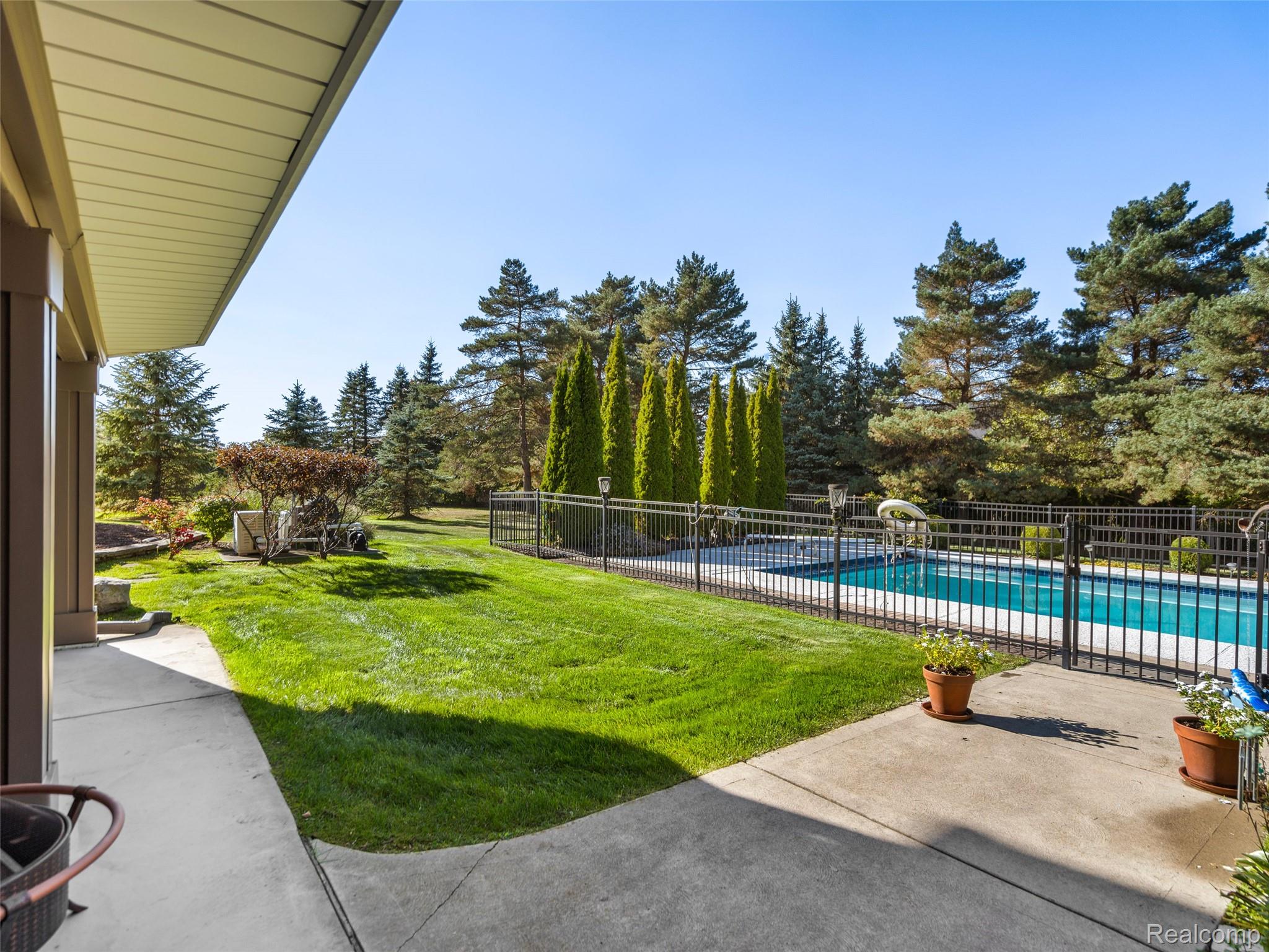 5724 Murfield Drive Rochester, MI 48306 - Photo 24 of 99 View of yard with a patio and view of scattered trees