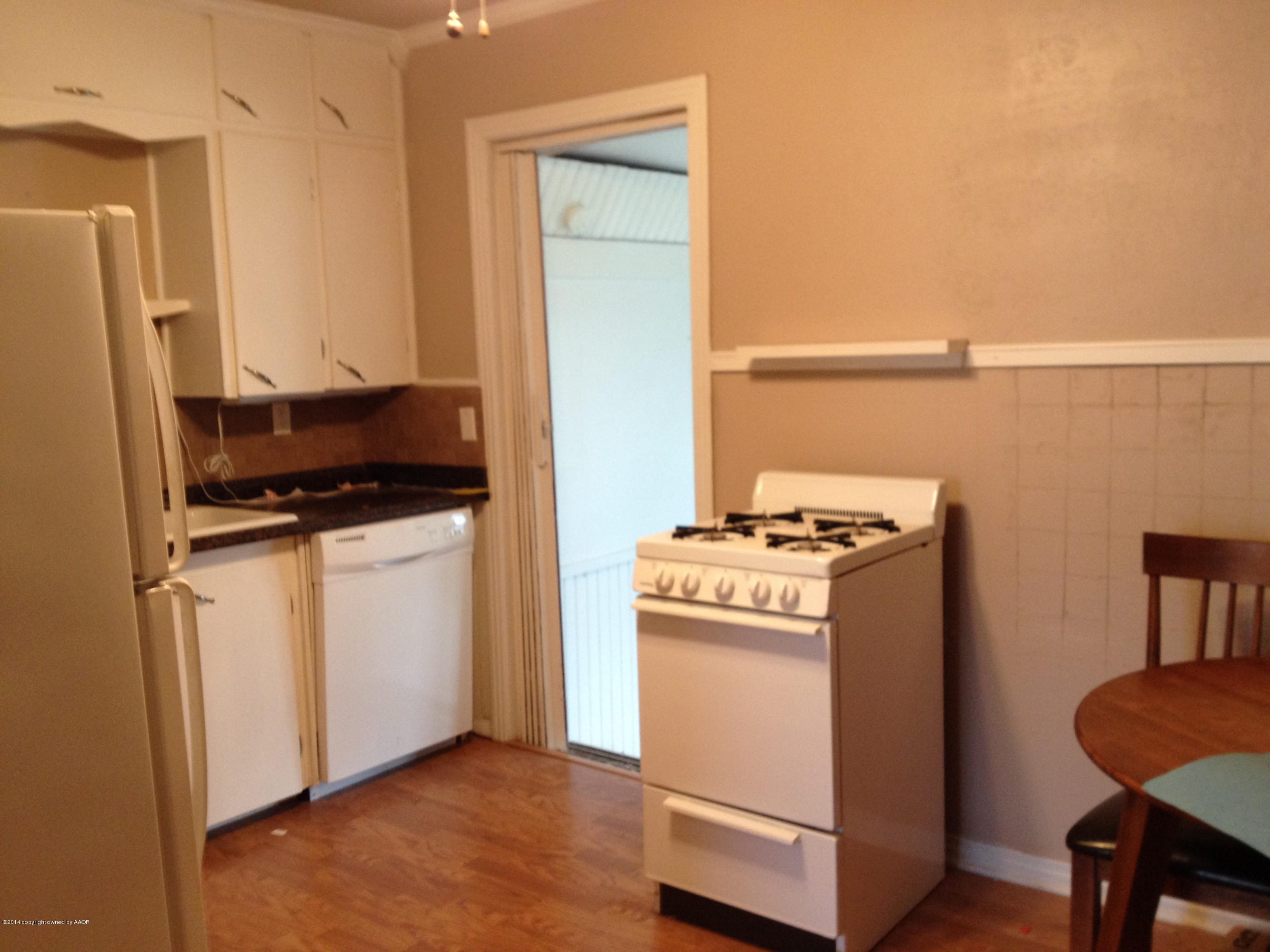 507 Southwest 44th Avenue Amarillo, TX 79110 - Photo 6 of 11 a kitchen with a stove and a refrigerator