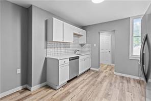 363 44th Street Pittsburgh, PA 15201 - Photo 6 of 14 a kitchen with a sink cabinets stainless steel appliances and a window