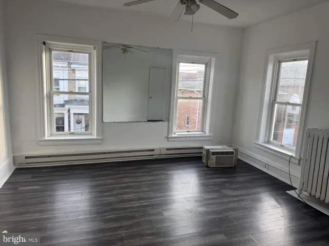 a view of room with window and hardwood floor