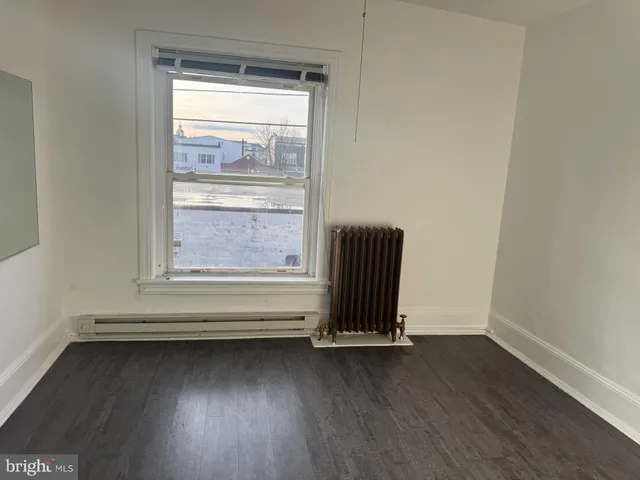 a view of a room with rack and wooden floor