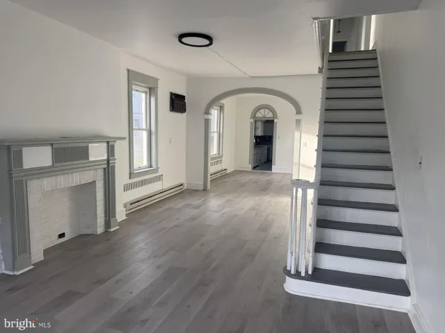a view of a room with wooden floors