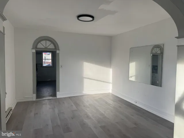 a large kitchen with granite countertop a stove a sink and a refrigerator