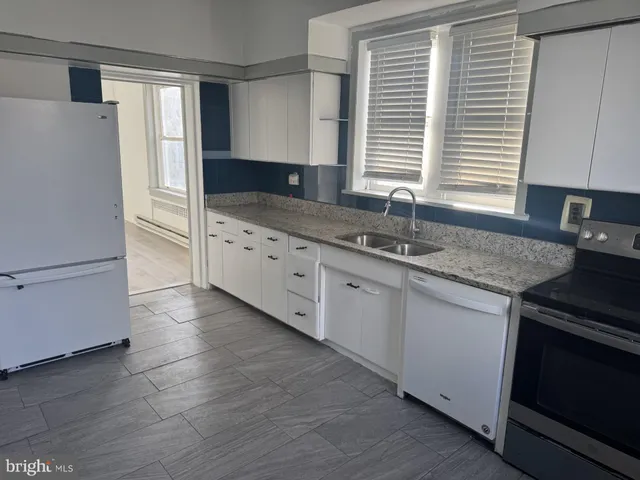 a white toilet sitting next to a shower