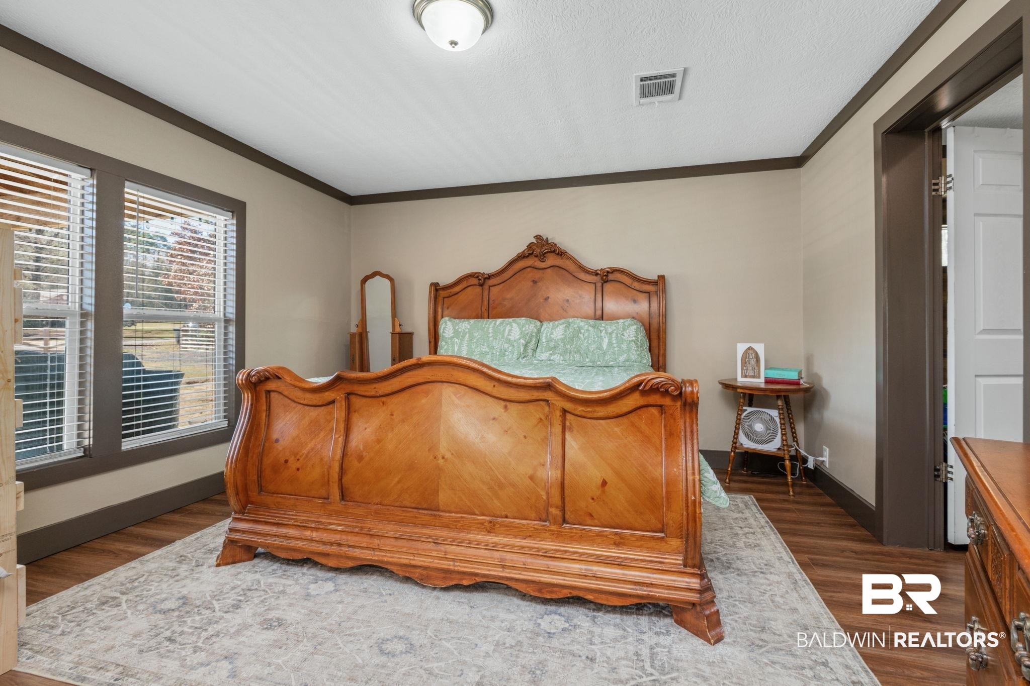 15080 Starlight Avenue Wilmer, AL 36587 - Photo 16 of 29 Bedroom with dark wood-type flooring, ornamental molding, and a textured ceiling