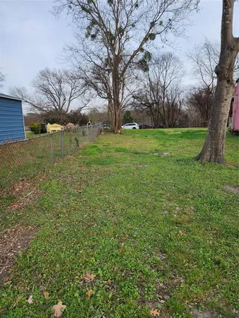a view of a backyard with large trees