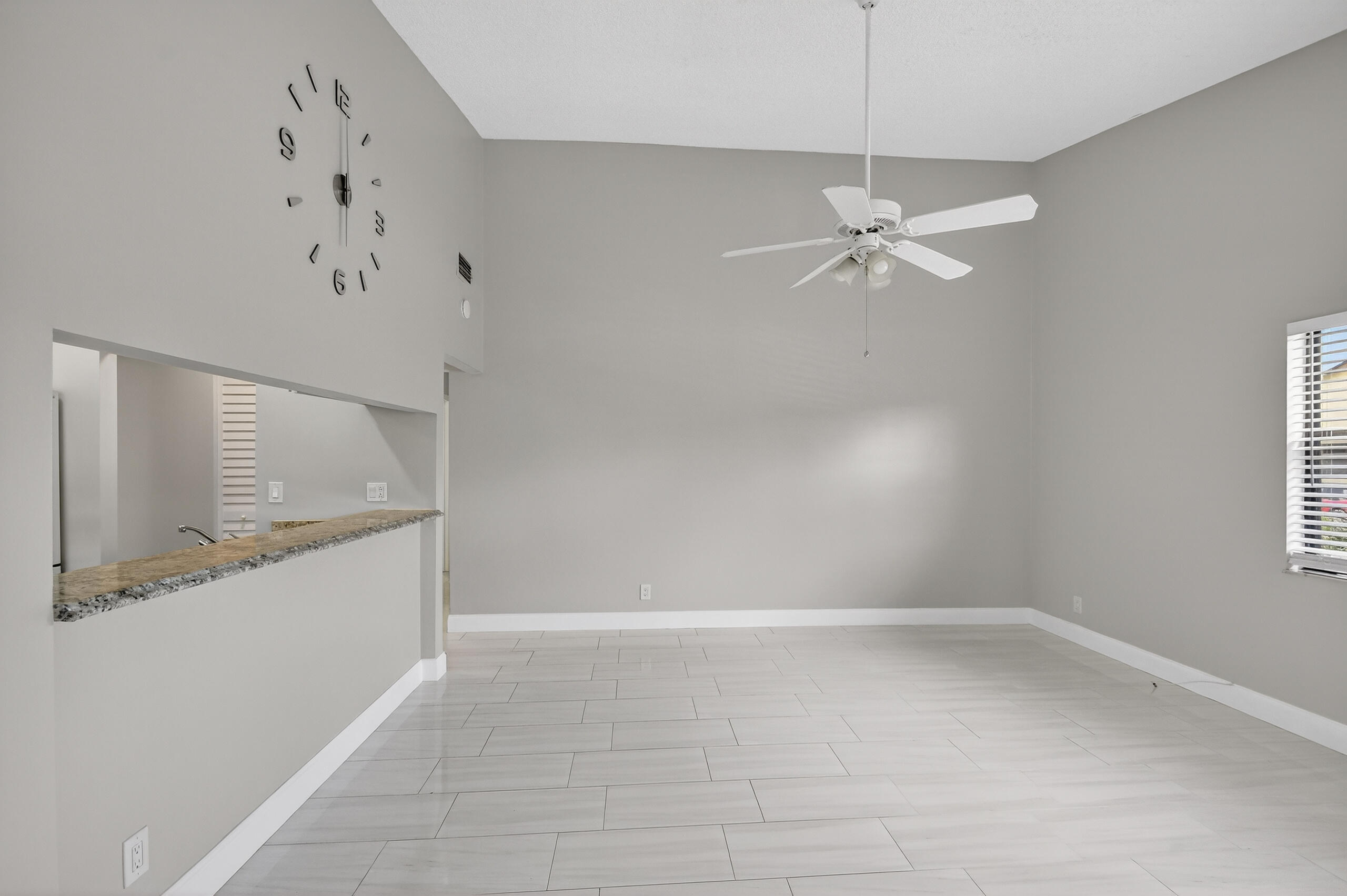 484 Springdale Circle, Unit 48D Palm Springs, FL 33461 - Photo 11 of 59 an empty room with a window and ceiling fan