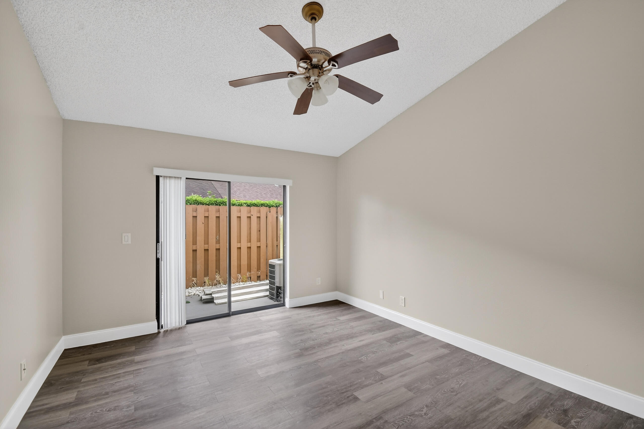 484 Springdale Circle, Unit 48D Palm Springs, FL 33461 - Photo 14 of 59 wooden floor in an empty room with a window