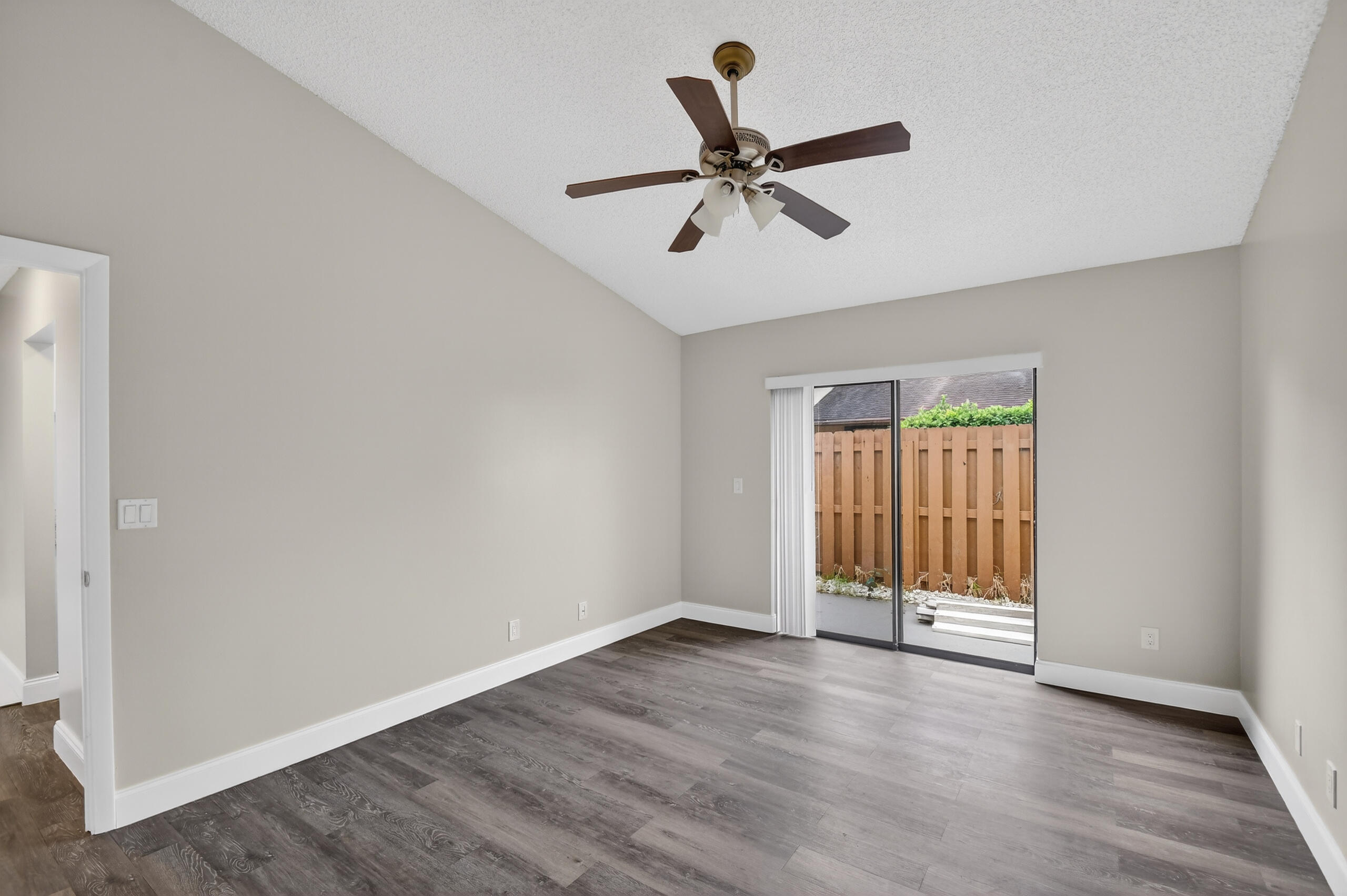 484 Springdale Circle, Unit 48D Palm Springs, FL 33461 - Photo 15 of 59 an empty room with wooden floor and windows