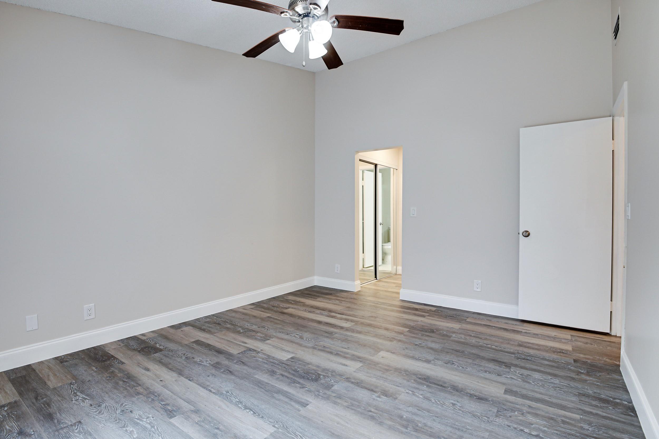 484 Springdale Circle, Unit 48D Palm Springs, FL 33461 - Photo 18 of 59 a view of an empty room with wooden floor