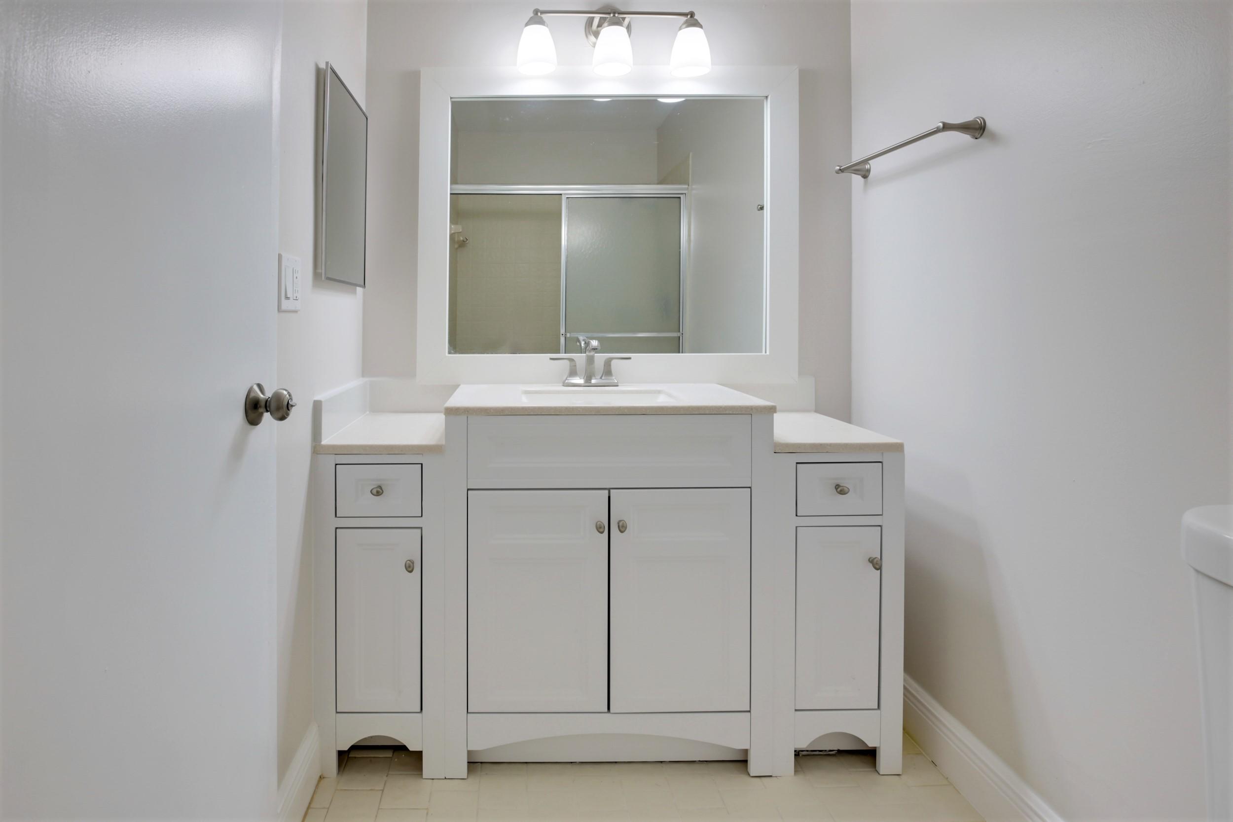484 Springdale Circle, Unit 48D Palm Springs, FL 33461 - Photo 21 of 59 a bathroom with a sink and a mirror