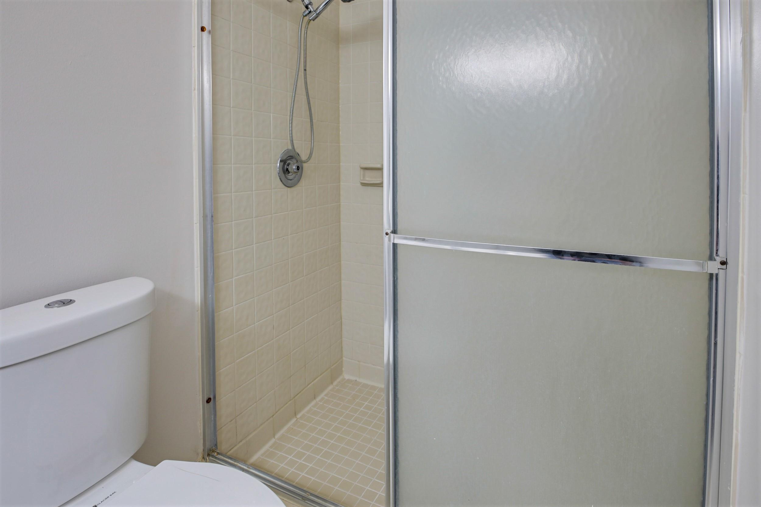 484 Springdale Circle, Unit 48D Palm Springs, FL 33461 - Photo 22 of 59 a bathroom with a shower and a toilet