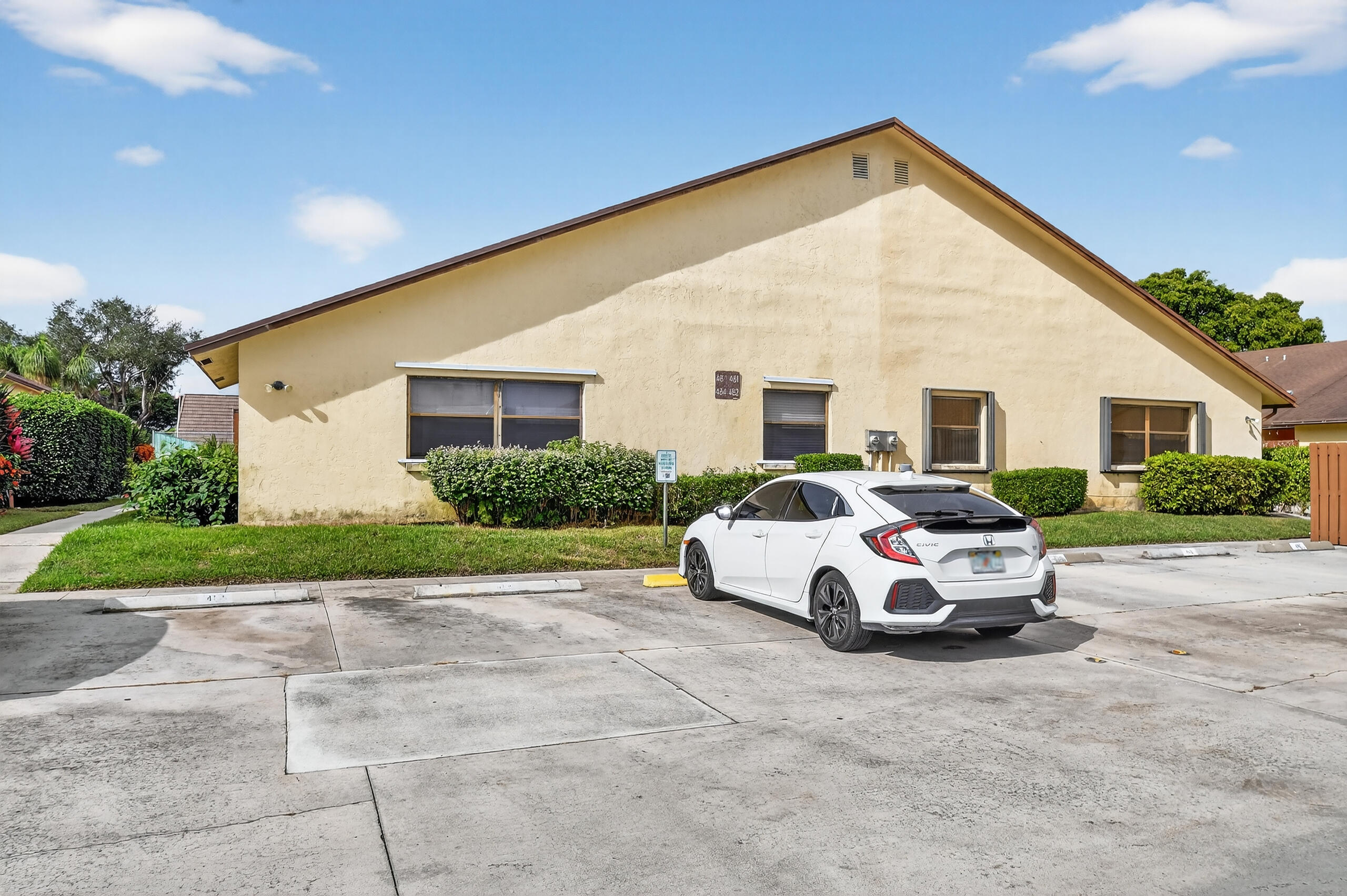 484 Springdale Circle, Unit 48D Palm Springs, FL 33461 - Photo 40 of 59 a car parked in front of house