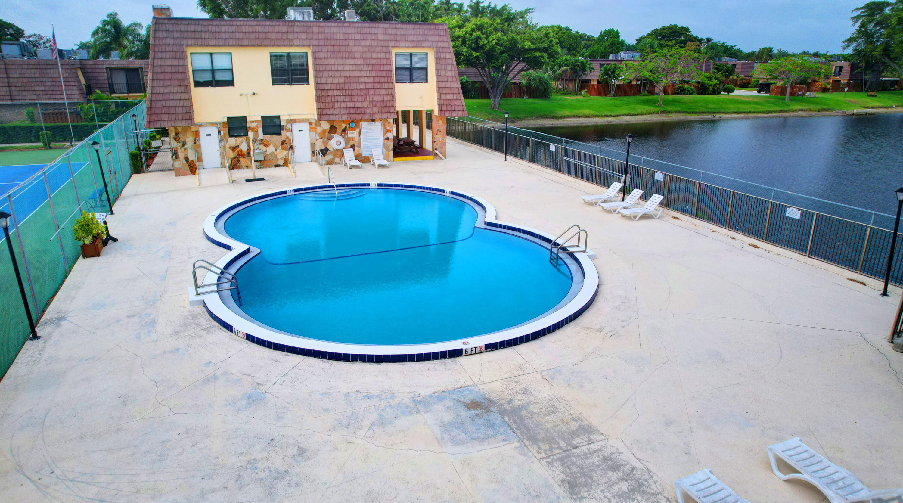 484 Springdale Circle, Unit 48D Palm Springs, FL 33461 - Photo 57 of 59 a view of a swimming pool with outdoor space and lake view
