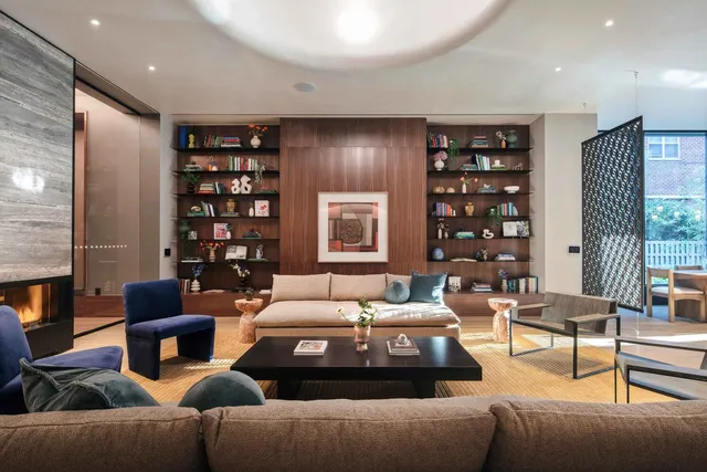 a living room with furniture and a bookshelf
