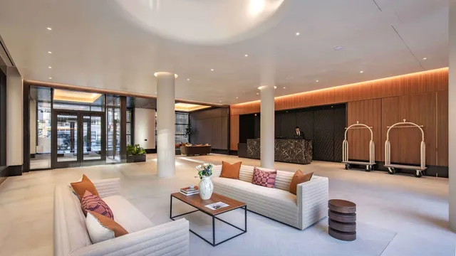 a living room with furniture gym equipment and large windows