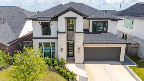 an aerial view of a house with a swimming pool