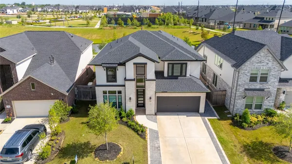 an aerial view of residential houses with outdoor space and swimming pool