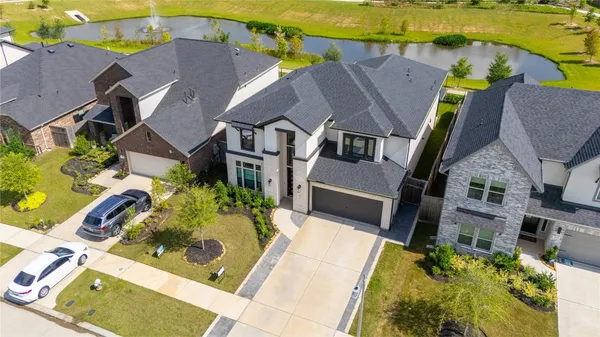 an aerial view of a house with a yard