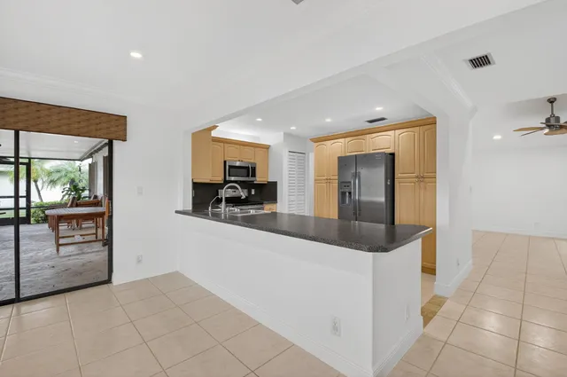 a kitchen with stainless steel appliances granite countertop a sink and a stove