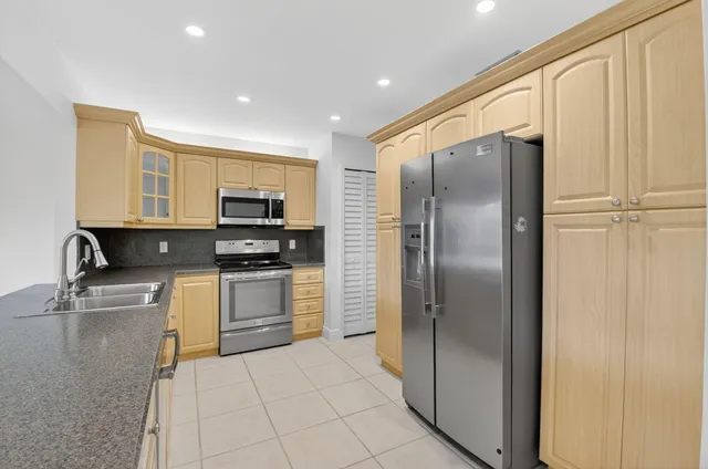 a kitchen with stainless steel appliances granite countertop a stove and a microwave