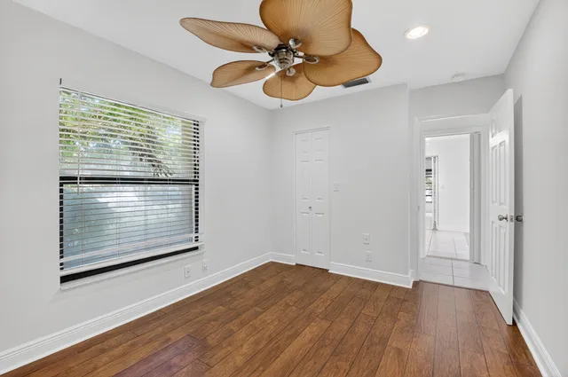 a view of an empty room with wooden floor